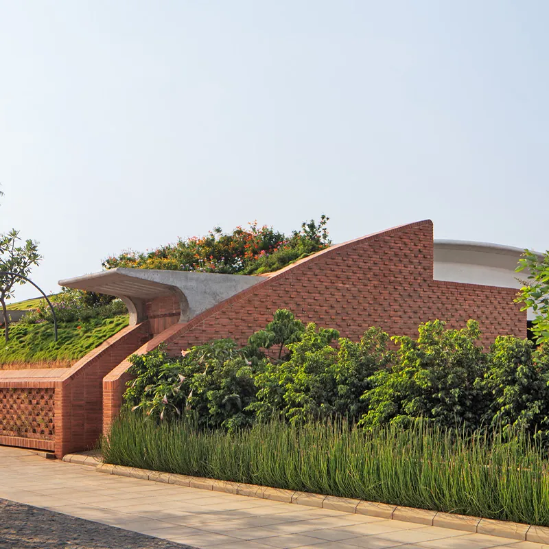 Total Environment After the Rain Green roof and brick facade of an earth-sheltered villa