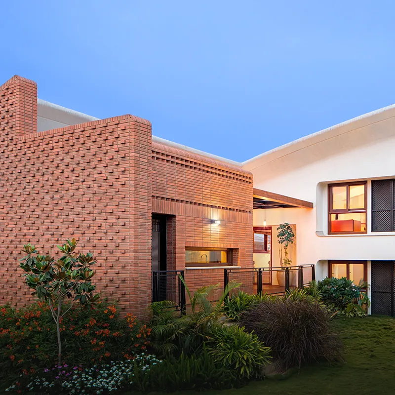 Total Environment After the Rain Brick villa set in a garden with lush planting