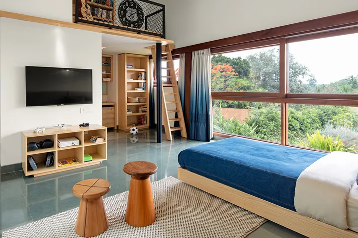 Children’s room with a play loft and garden views