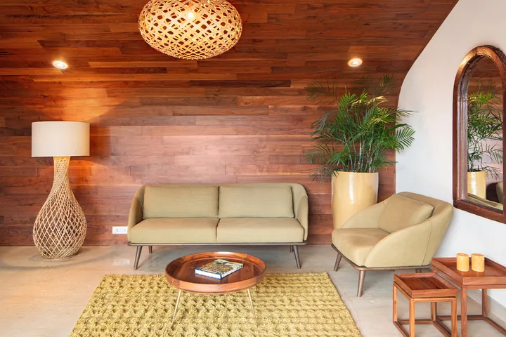 Living room with warm wood panelling and an arched mirror